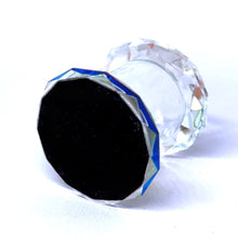 Clear glass knob with black center on a white background
